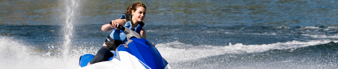 A woman riding a Sea-Doo on the water