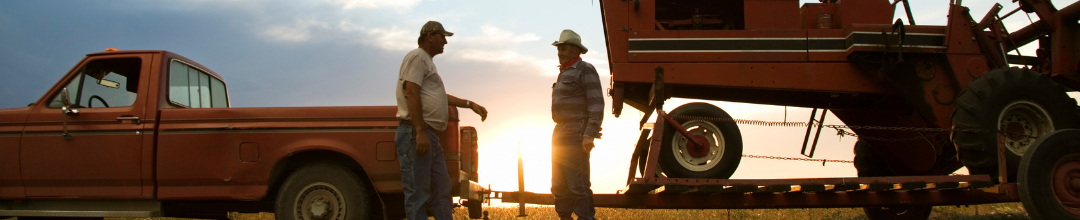 A truck owner and tow truck on the road at sunset