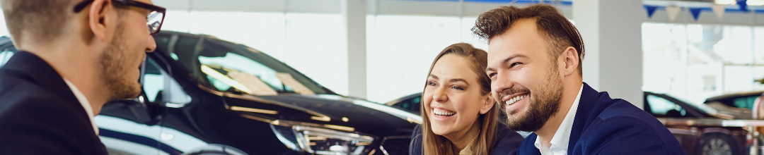 Couple talking to a car dealer