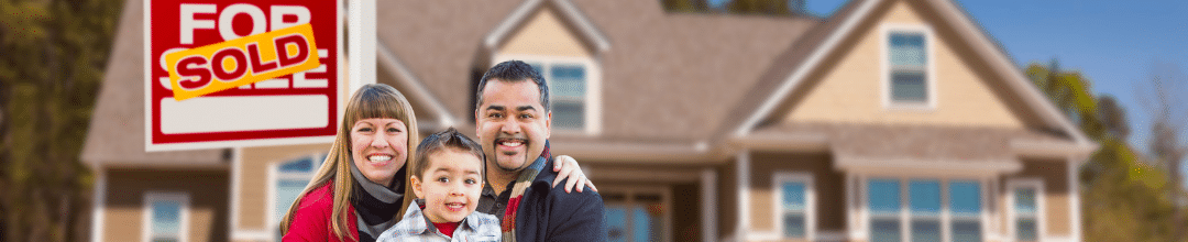 A family of 3 in front of their new home with a SOLD sign